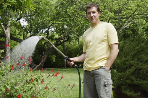 Landscapers working with plants and turf on a site